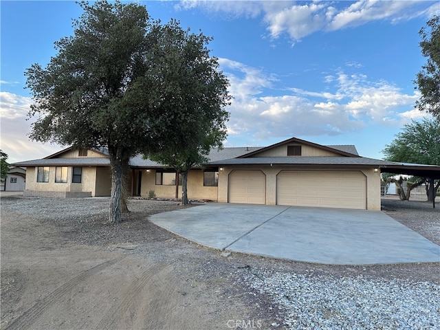 ranch-style home with a carport and a garage