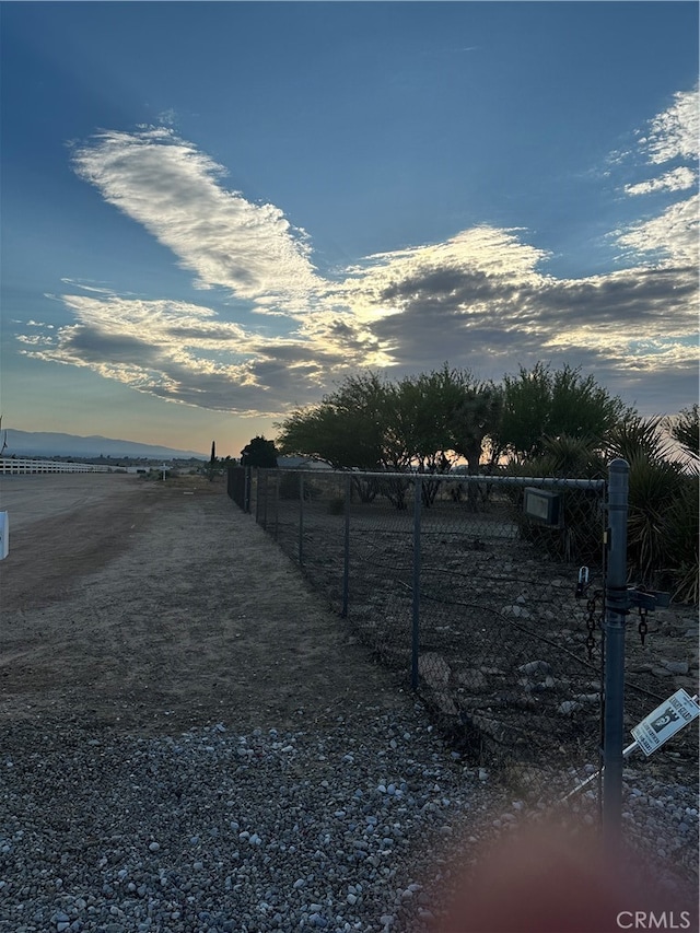 yard at dusk with a rural view