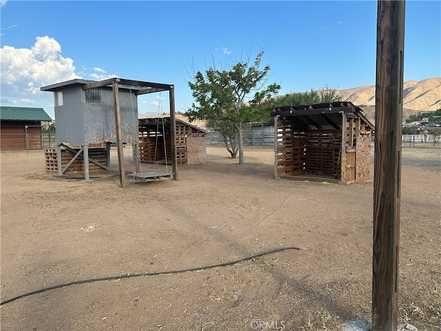 exterior space featuring an outbuilding and a mountain view