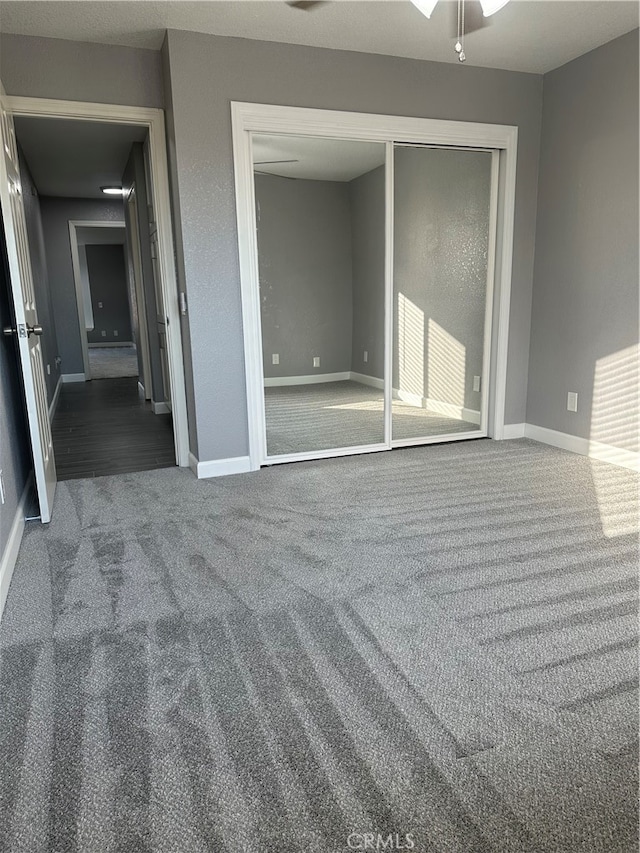 unfurnished bedroom with carpet flooring and a closet