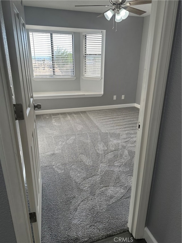 carpeted spare room with ceiling fan