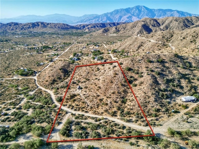 birds eye view of property with a mountain view