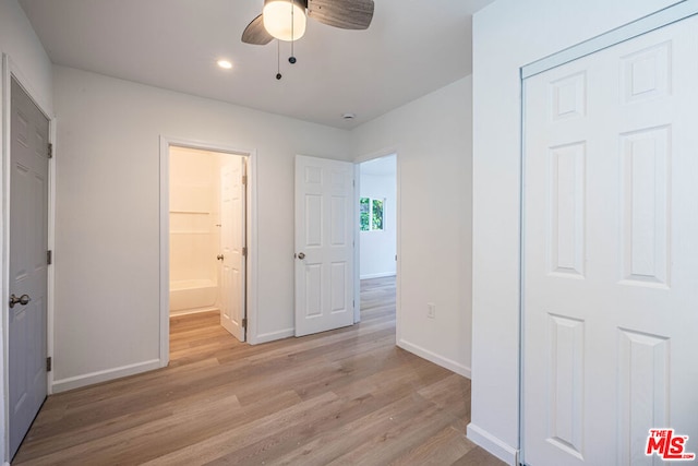 unfurnished bedroom with ceiling fan, a closet, and light hardwood / wood-style flooring