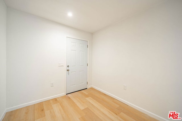 spare room with wood-type flooring