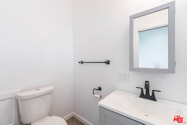 bathroom with toilet and vanity