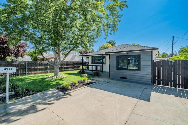 rear view of property featuring a lawn and a patio area