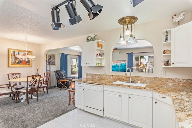 kitchen featuring dishwasher, white cabinetry, plenty of natural light, and sink