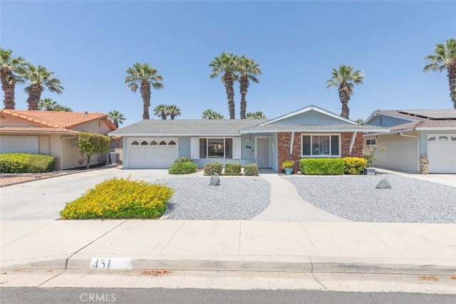 single story home featuring central AC and a garage