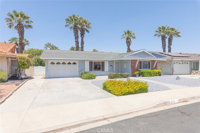 ranch-style home with solar panels and a garage