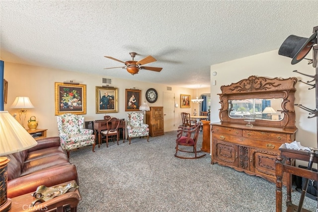 living room with carpet flooring, ceiling fan, and a textured ceiling