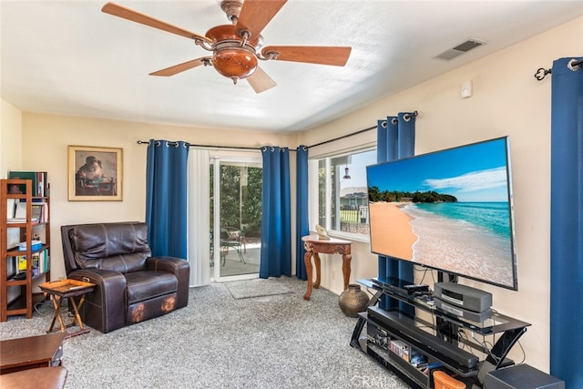 living room with carpet and ceiling fan