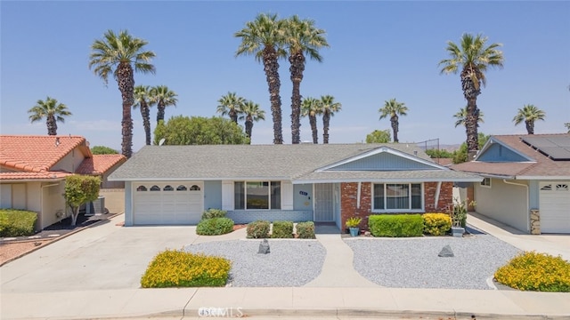 ranch-style home with central air condition unit and a garage