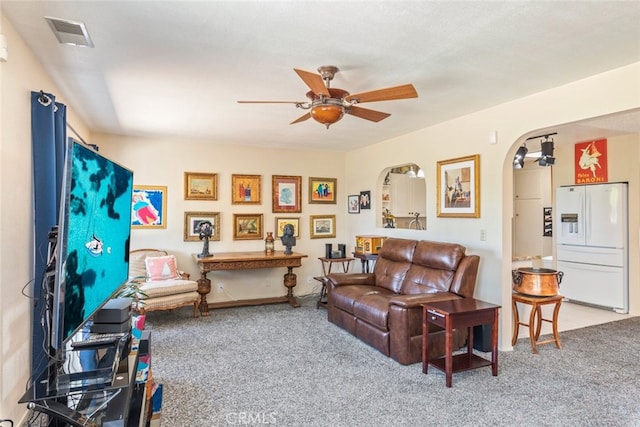 carpeted living room featuring ceiling fan