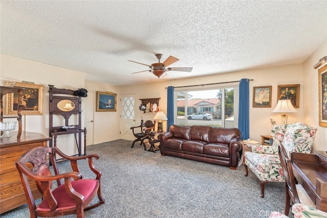 carpeted living room with ceiling fan and a textured ceiling