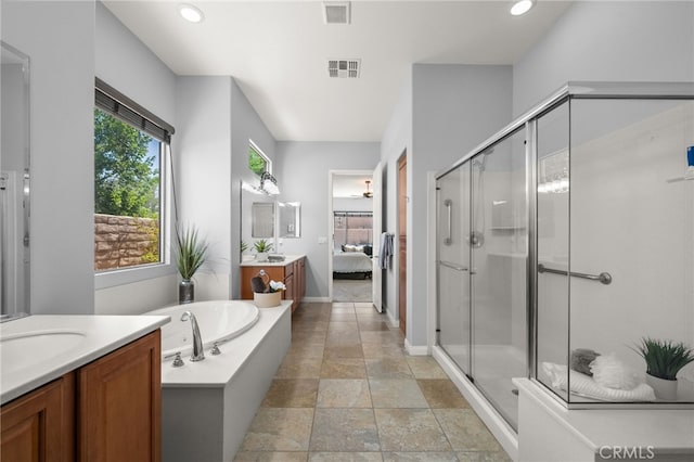 bathroom featuring separate shower and tub and vanity