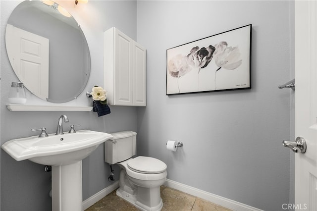 bathroom with sink, toilet, and tile patterned floors