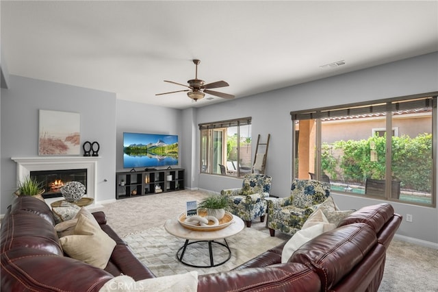 carpeted living room with ceiling fan