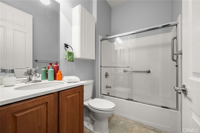 full bathroom featuring vanity, toilet, and bath / shower combo with glass door