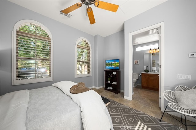 bedroom featuring ensuite bath and ceiling fan