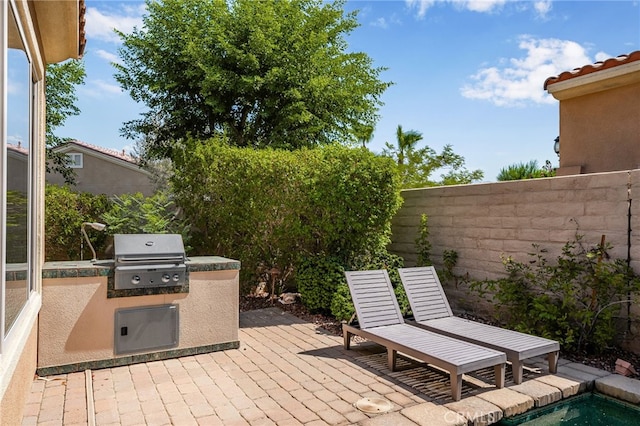 view of patio with exterior kitchen and area for grilling