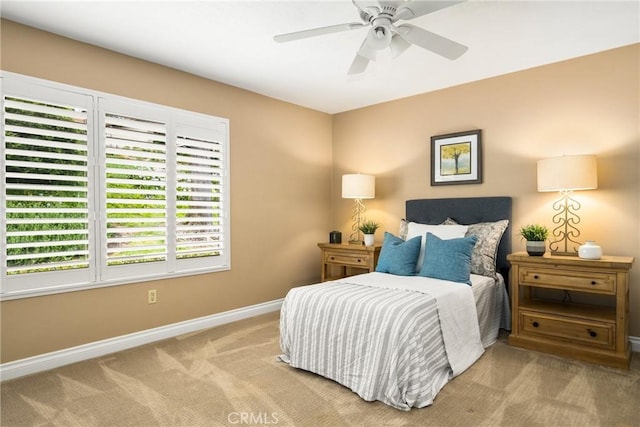 bedroom with ceiling fan, carpet, and baseboards