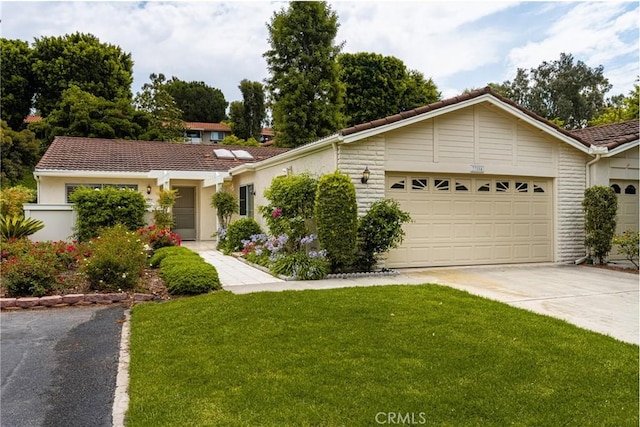 ranch-style home with a garage and a front yard