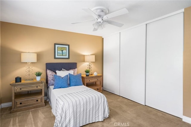 bedroom featuring a closet, carpet, and a ceiling fan