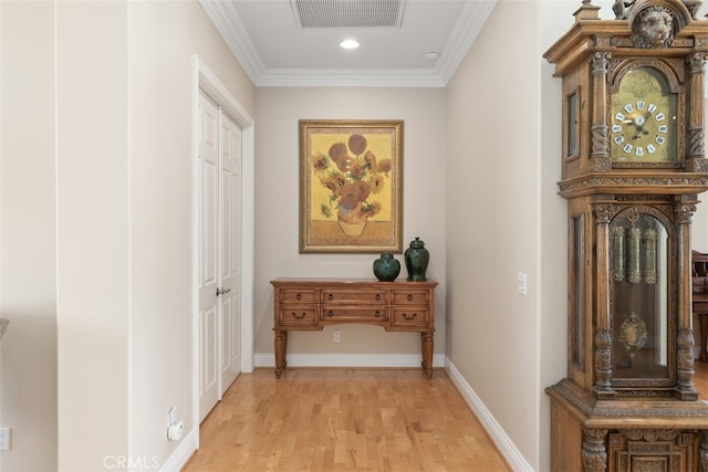 hall featuring crown molding and light wood-type flooring