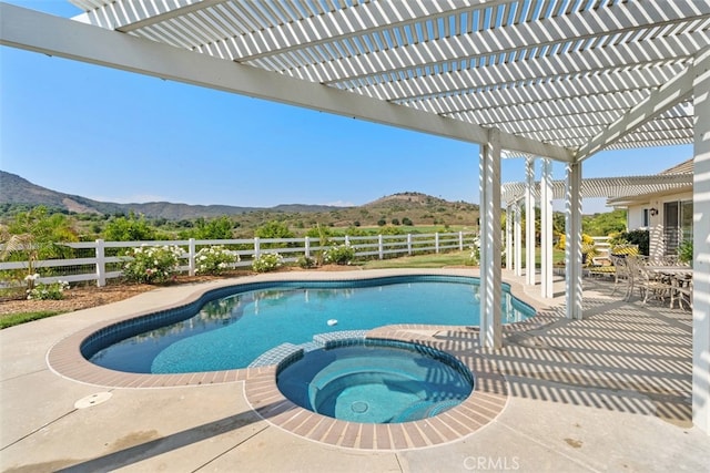 view of swimming pool with an in ground hot tub, a mountain view, a patio, and a pergola