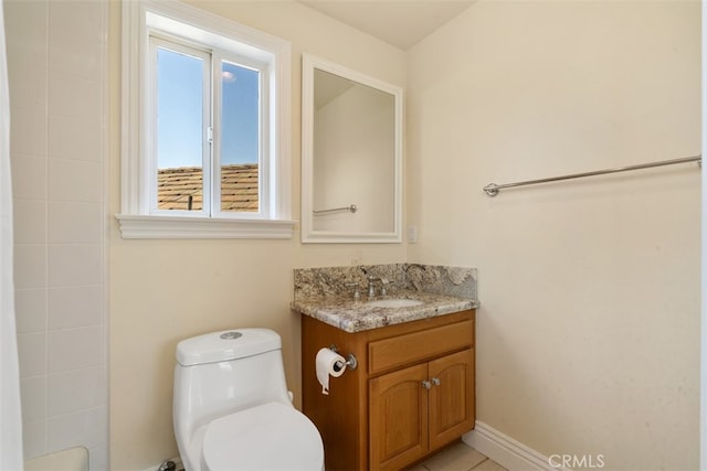 bathroom with toilet, walk in shower, vanity, and tile patterned floors