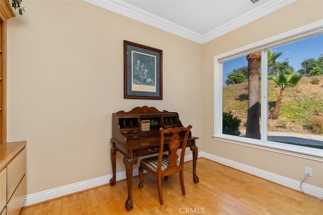 office space featuring light hardwood / wood-style flooring, plenty of natural light, and crown molding