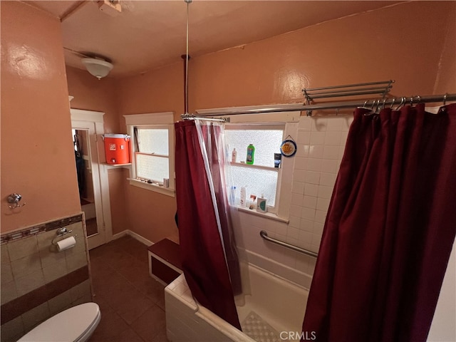 bathroom with tile patterned flooring, shower / bath combination with curtain, and toilet