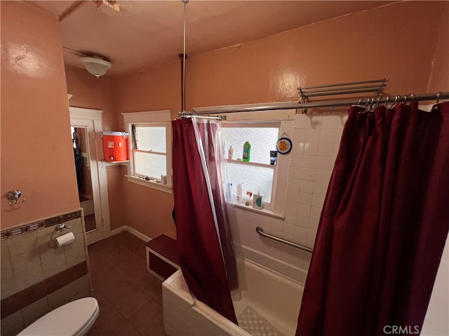 bathroom with shower / bath combination with curtain, toilet, and tile patterned flooring