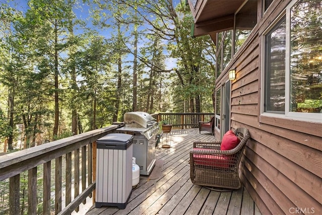 wooden terrace featuring a grill