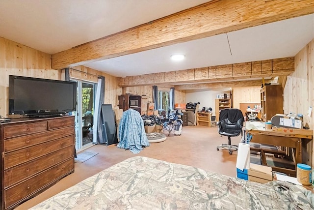 bedroom featuring concrete flooring, access to exterior, and wood walls