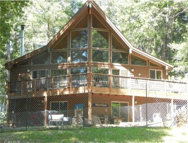 rear view of house featuring a wooden deck