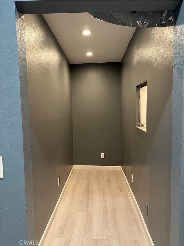 interior space with recessed lighting, baseboards, and wood finished floors