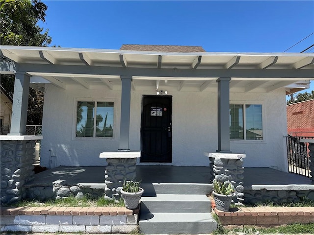 property entrance featuring covered porch