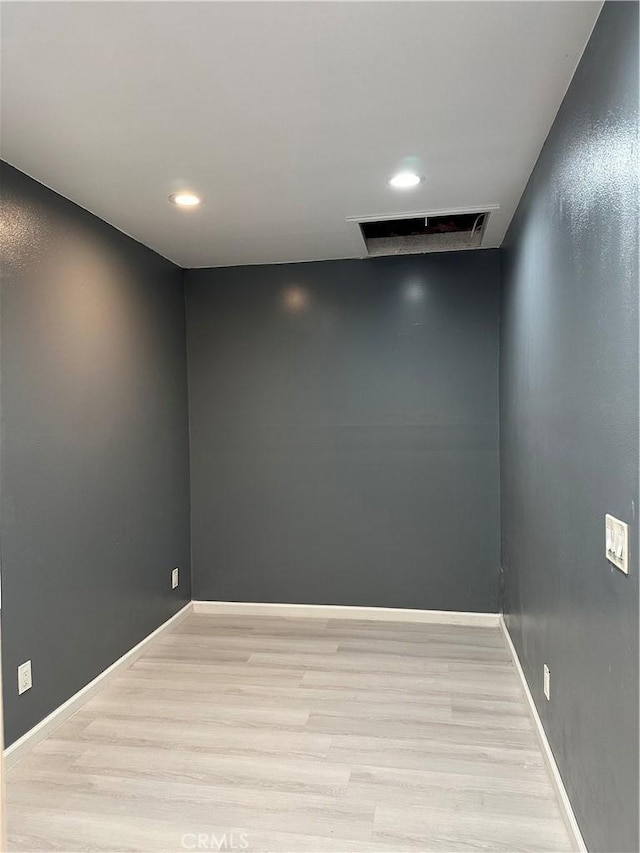 empty room with light wood-type flooring, baseboards, visible vents, and recessed lighting