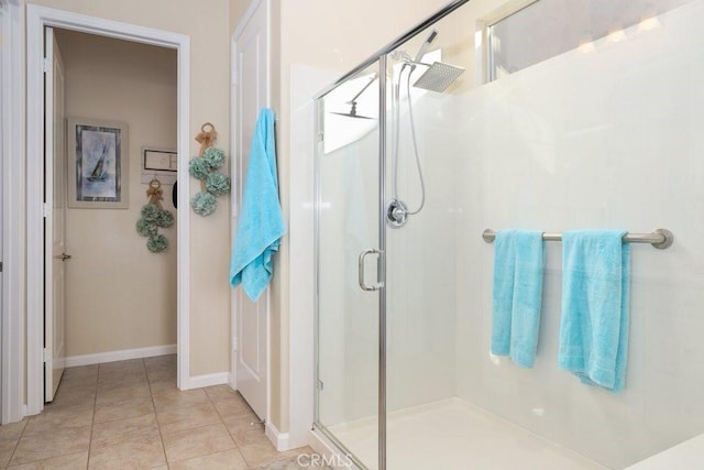 bathroom featuring tile patterned flooring and an enclosed shower