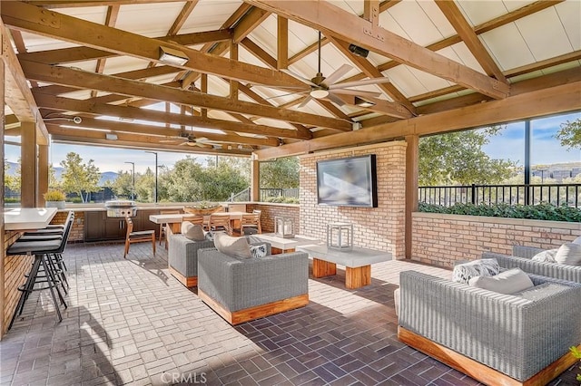 view of patio / terrace with a gazebo, an outdoor living space, exterior bar, and an outdoor kitchen