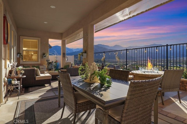 patio terrace at dusk with a mountain view and an outdoor living space