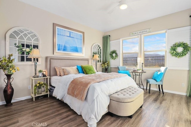 bedroom with ceiling fan and hardwood / wood-style flooring