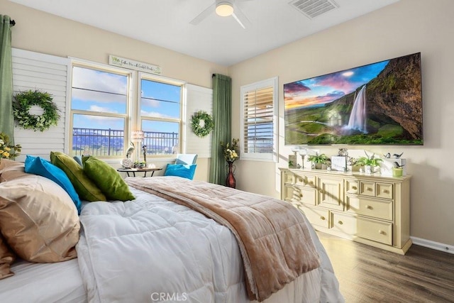 bedroom with ceiling fan and wood-type flooring