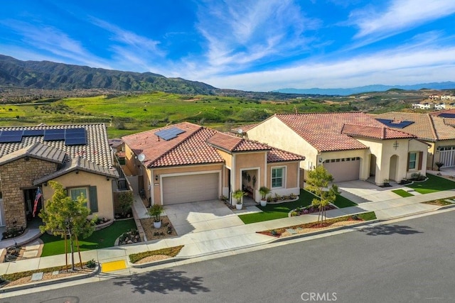 mediterranean / spanish house featuring a mountain view and a garage