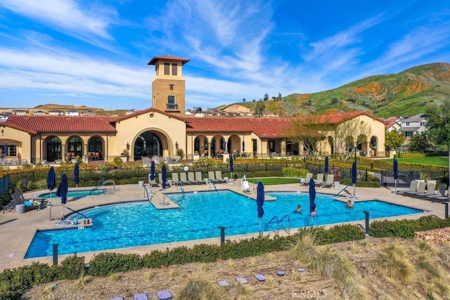 view of swimming pool featuring a mountain view and a patio