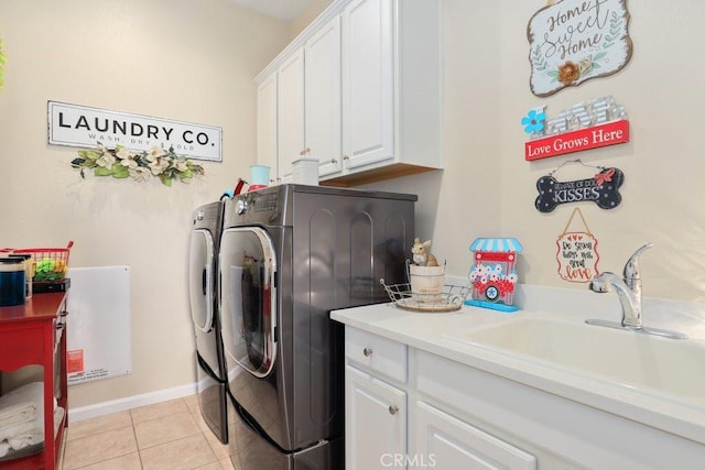 laundry area with cabinets, independent washer and dryer, light tile patterned flooring, and sink