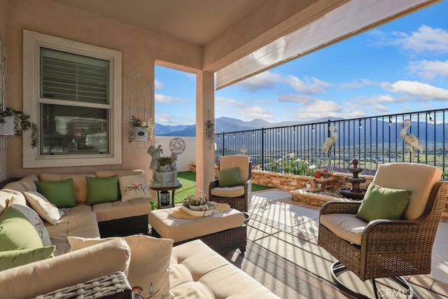 exterior space featuring outdoor lounge area and a water and mountain view