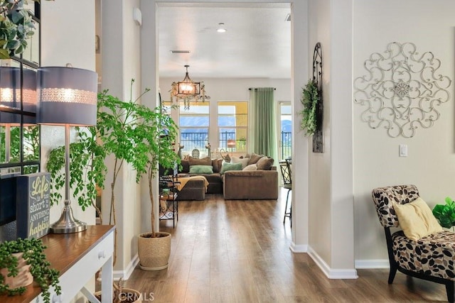 interior space with a chandelier and hardwood / wood-style floors