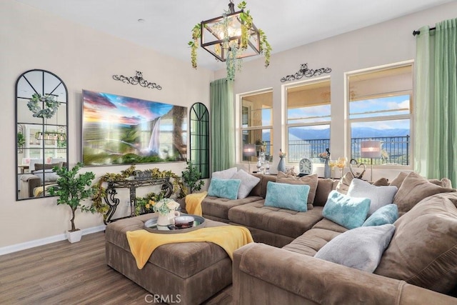 living room featuring an inviting chandelier and hardwood / wood-style flooring